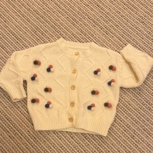 Cream Cardigan with Colorful Pom Poms